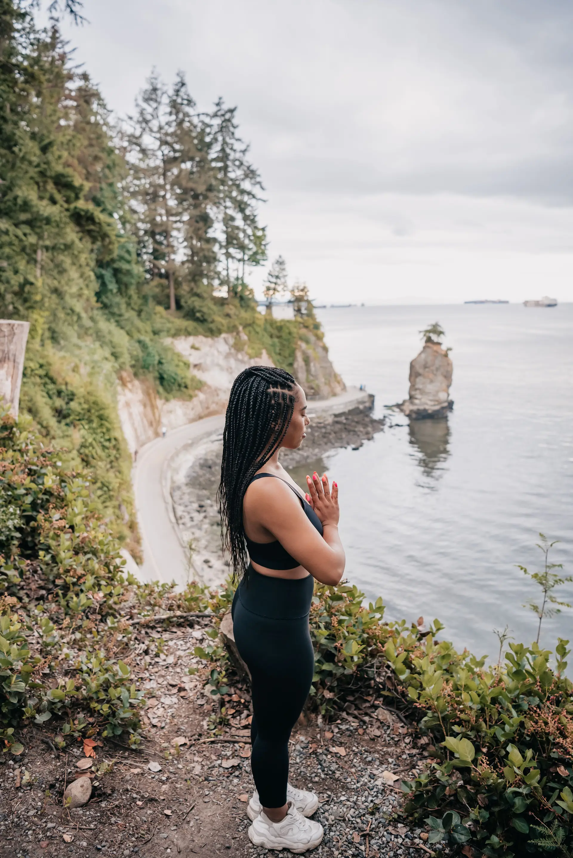 Person pausing mindfully near a Canadian coastal landscape